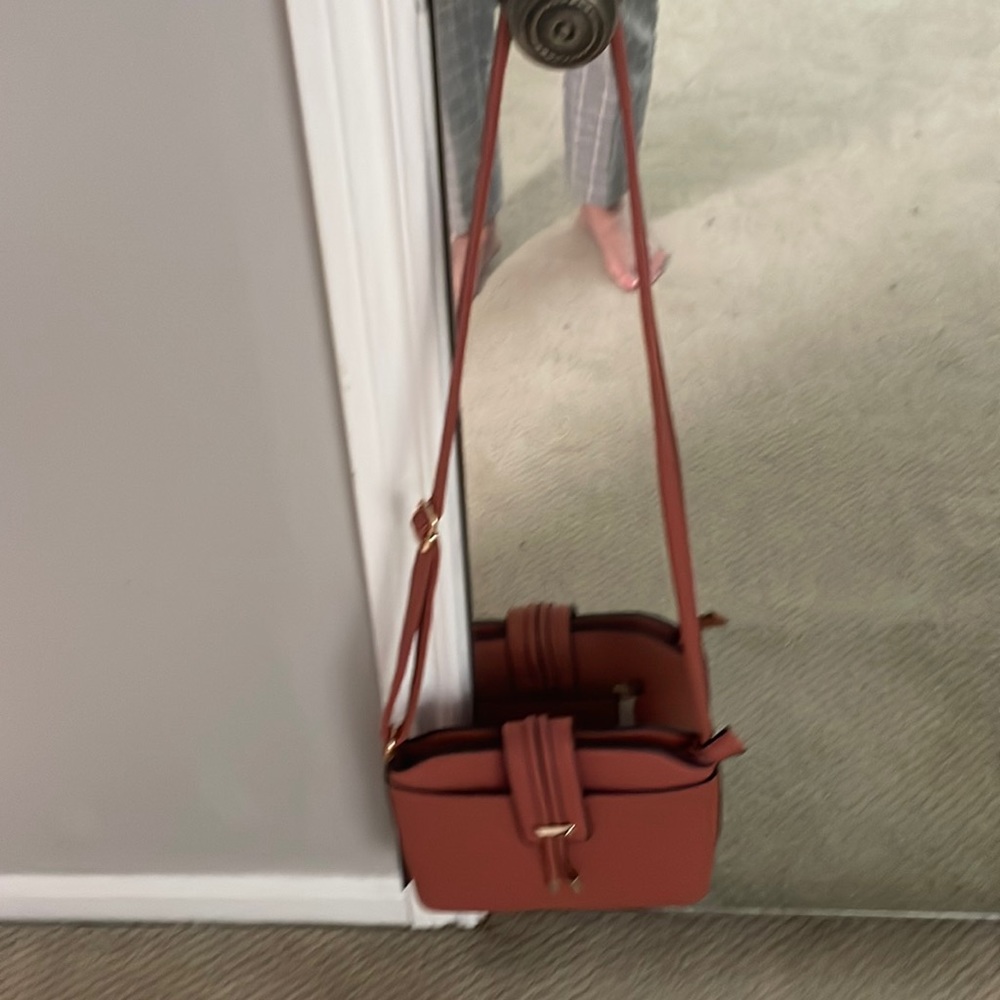 Coral color purse.  Brand new with tags attached.